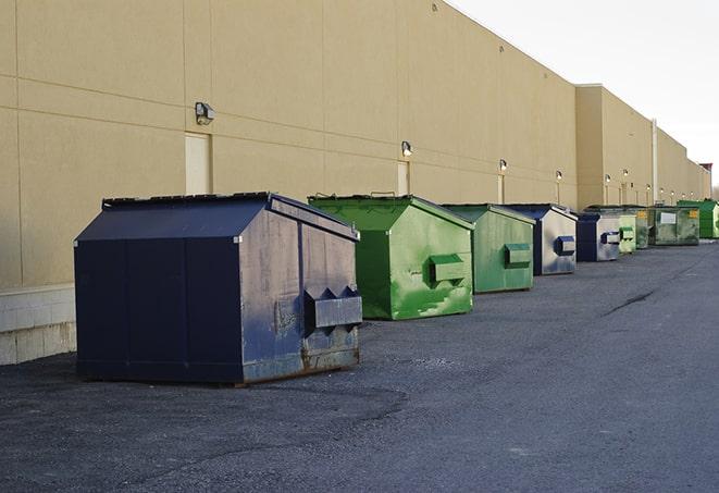 a yellow construction dumpster filled with waste materials in Bourg